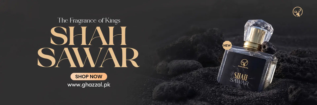 A perfume bottle labeled Shah Sawar is shown on a dark textured background beside large gold text reading 'The Fragrance of Kings' and 'SHAH SAWAR,' with a small 'SHOP NOW' button and website text.