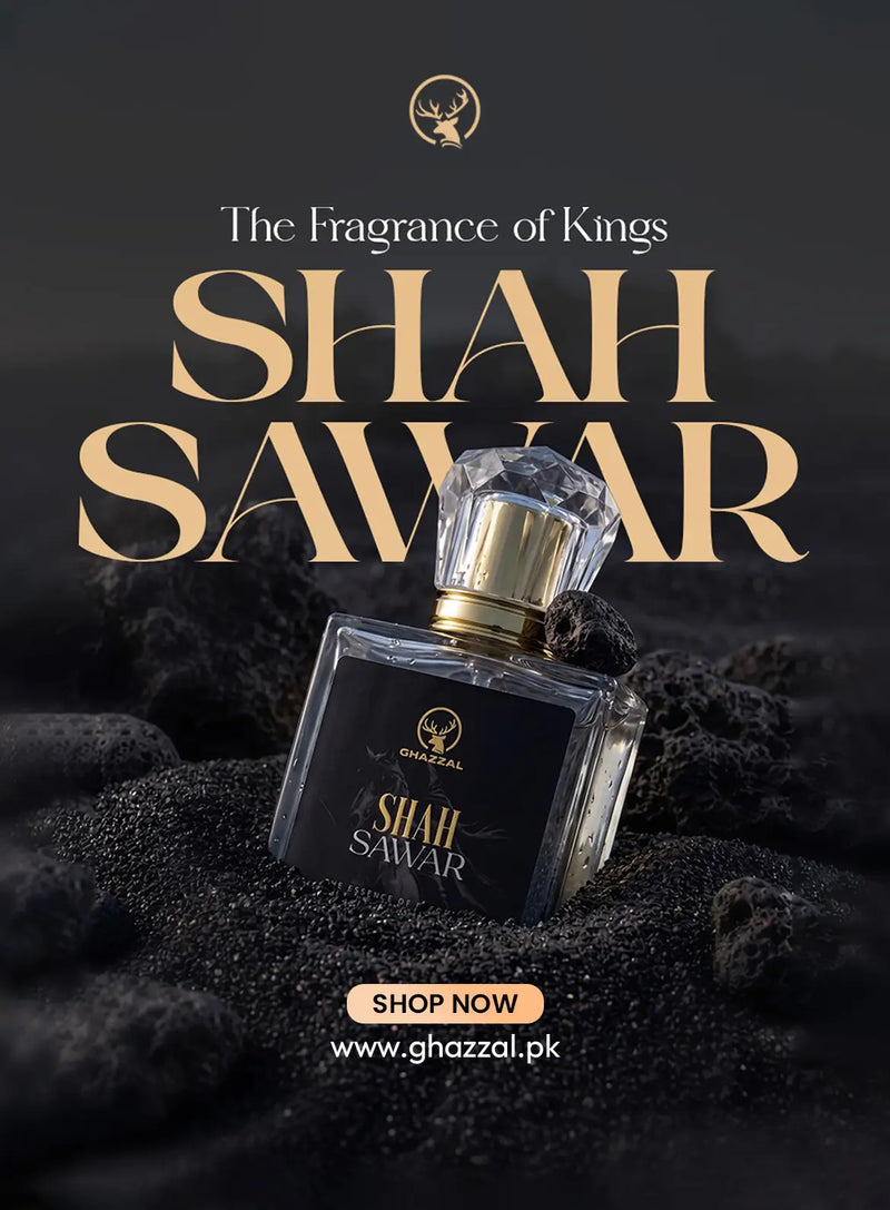 A perfume bottle labeled Shah Sawar by Ghazzal, shown on a dark textured surface with large gold and white promotional text above it. The bottle is clear glass with a black label and a faceted clear cap, set against a dark charcoal background.